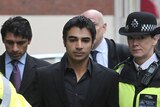 British police escort former Pakistan cricket captain Salman Butt from the court.