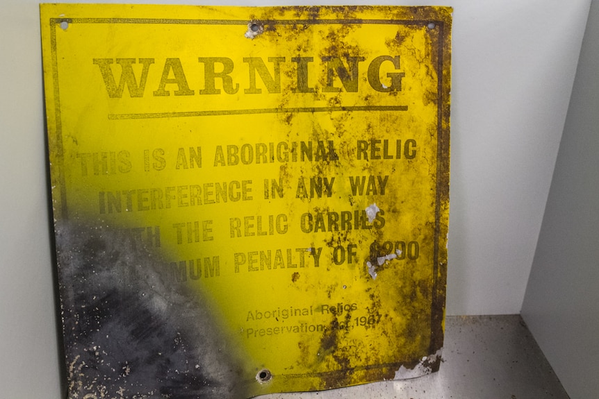 An old sign warning tourists of relics on North Stradbroke Island.