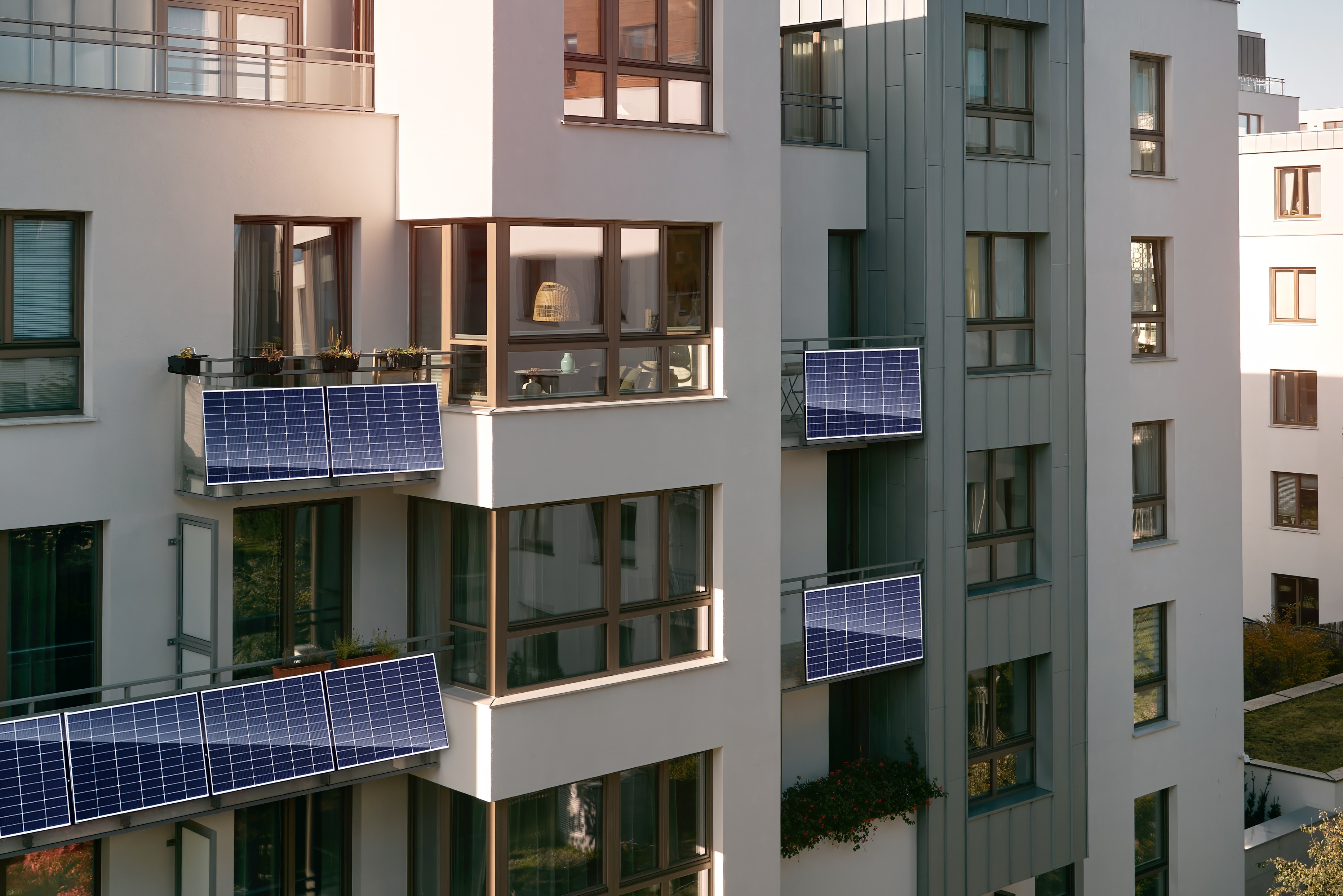 An apartment building with plug-in solar panels on the balconies.
