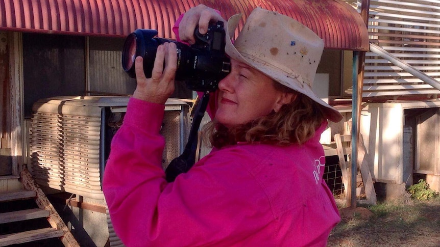 Grazier Ann Britton takes a photo at her property Goodwood Station in north-west Queensland.