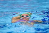 A photo of a swimmer under the water.