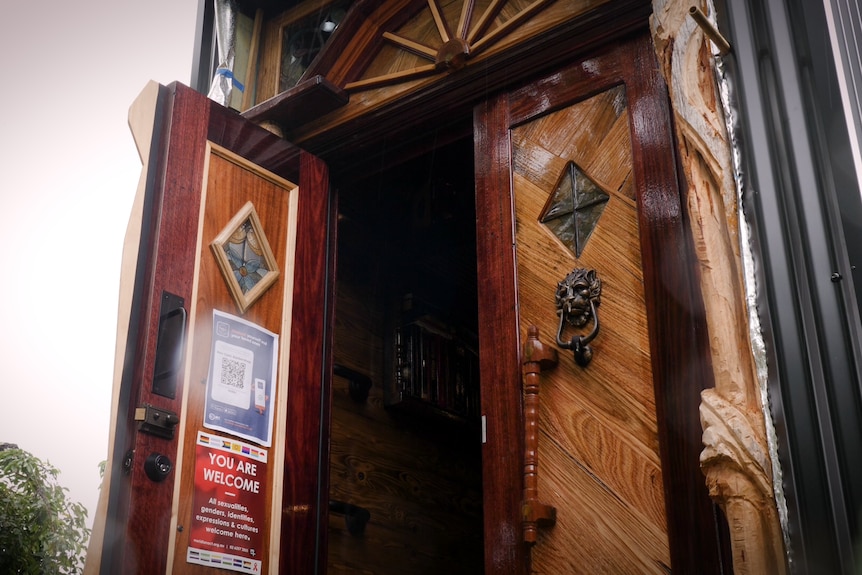 The van's front is made up of beautifully carved timber, including a door-knocker with an animal face.