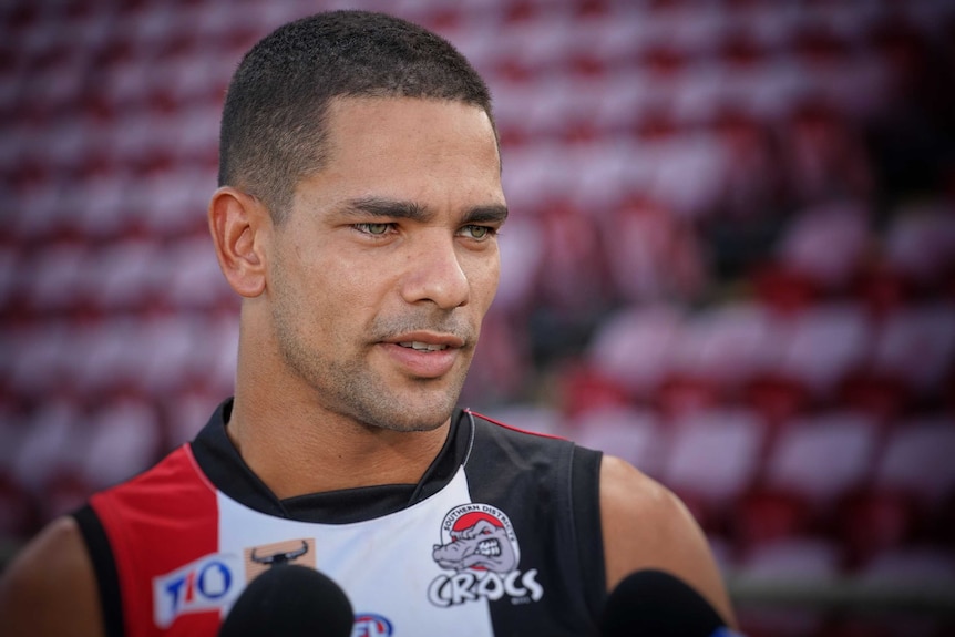 Will Farrer speaks to the media at a football stadium