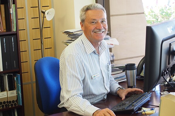 City of Karratha mayor Peter Long sits at his desk in front of a computer