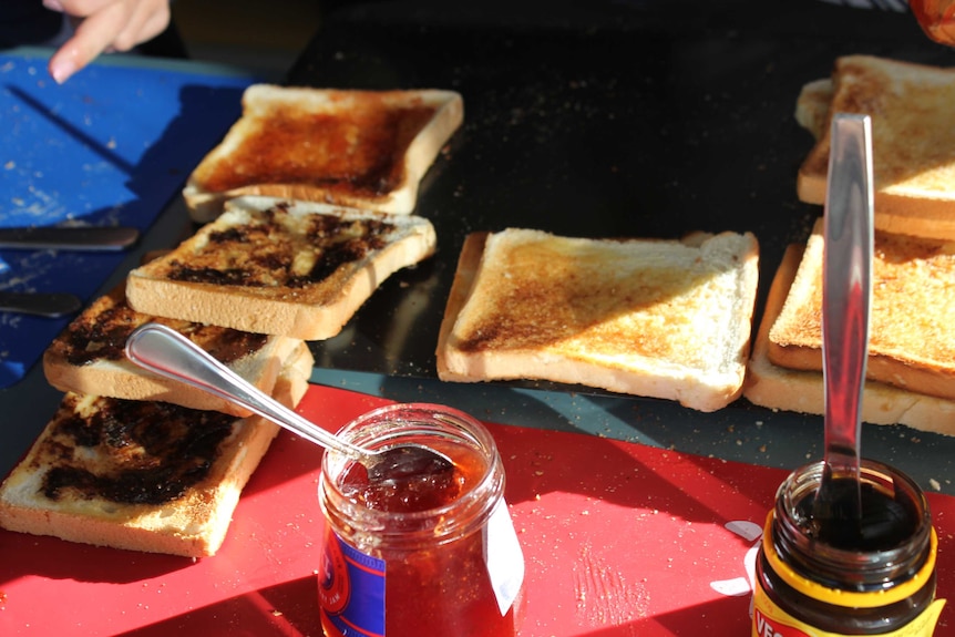 Toast with various spreads on a shopping board.