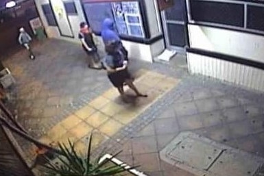 CCTV footage of some people outsde a buiding.
