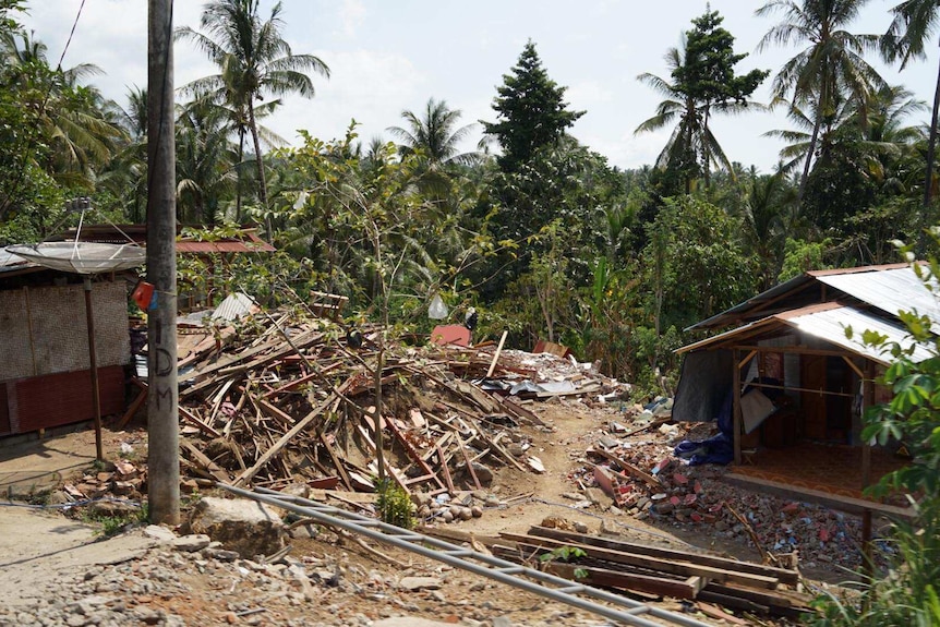 Houses in Lombok reduced to rubble by a series of earthquakes in August, now look like a pile of wood and rocks on the ground