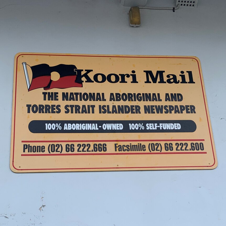 A Koori Mail logo sign on a wall