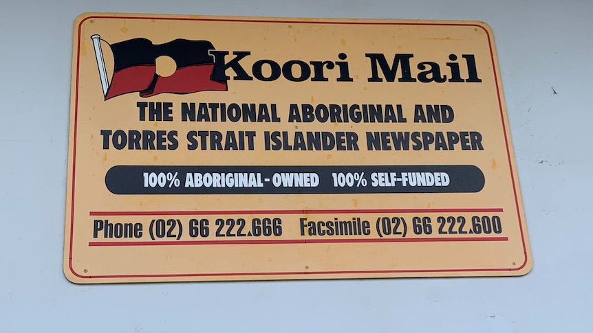 A Koori Mail logo sign on a wall