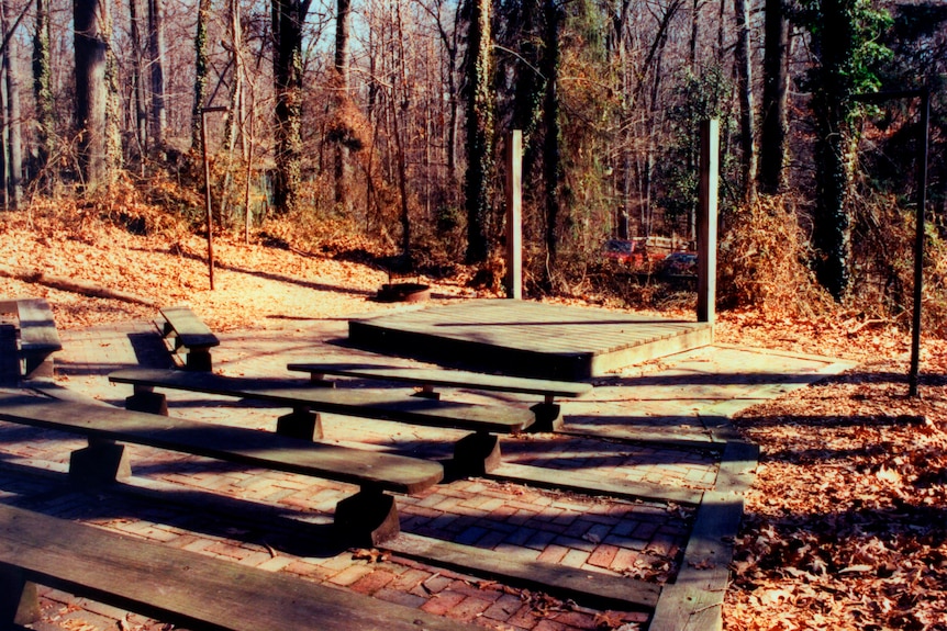 A small stage and benches in a wooded area of Virginia in the United States.
