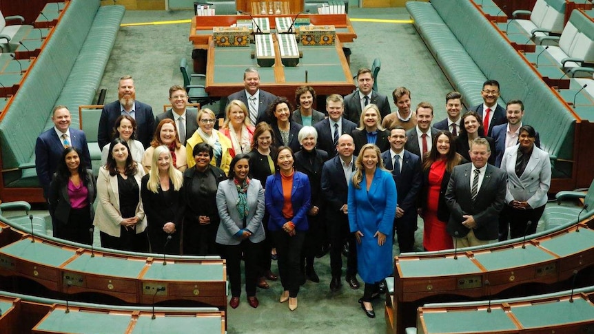 Thirty-five MPs pose for a photo on the floor of the House of Representatives.