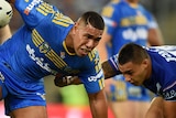 Parramatta's Vai Afu Toutai is tackled by the Bulldogs' Michael Lichass at the Olympic stadium.