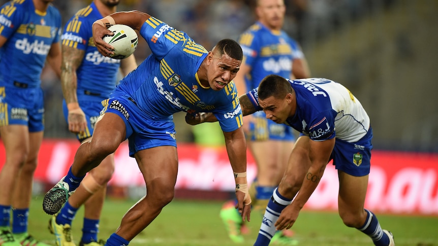 Parramatta's Vai Afu Toutai is tackled by the Bulldogs' Michael Lichass at the Olympic stadium.