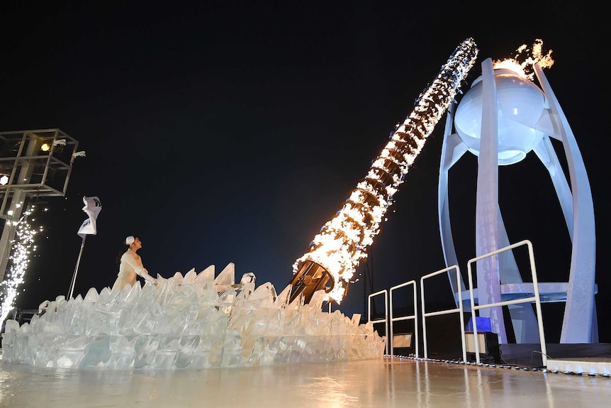 Figure skating champion Yuna Kim lights the Olympic flame