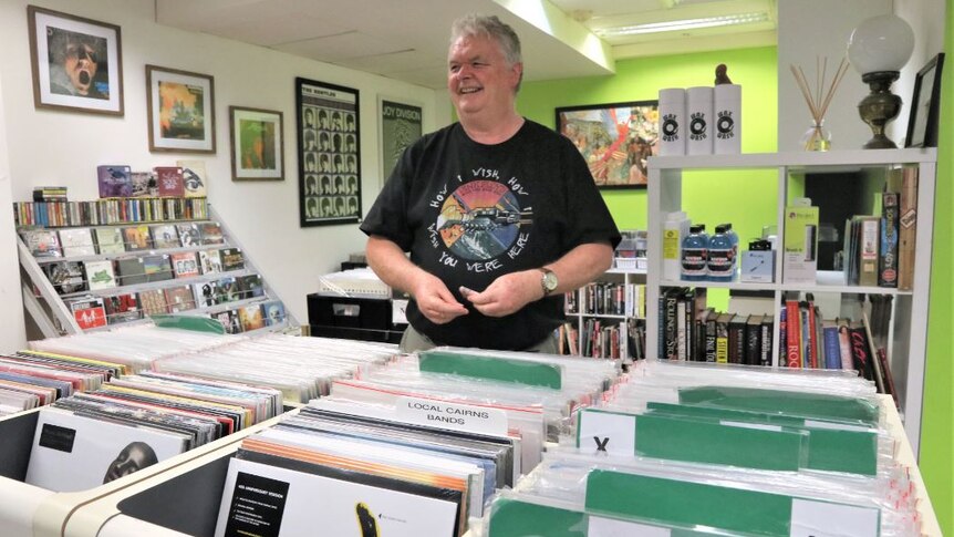 Man standing in a record store.