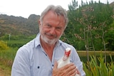 Actor Sam Neill holds a duck