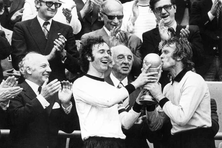 Franz Beckenbauer holds the World Cup