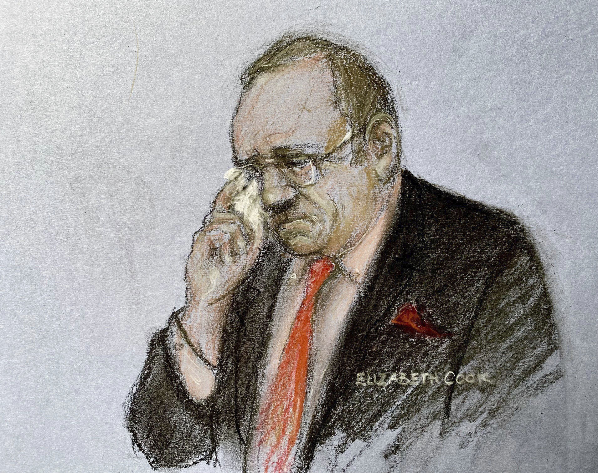 A court sketch of a man wiping a tear from his face with a tissue 