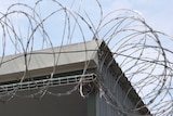 Barbed wire on a jail fence.