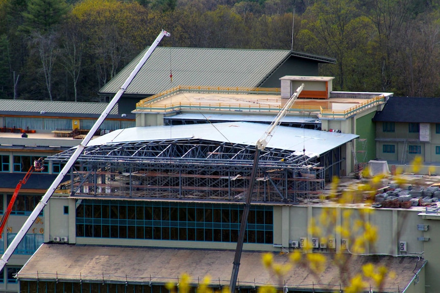 Cranes and an unfinished roof.