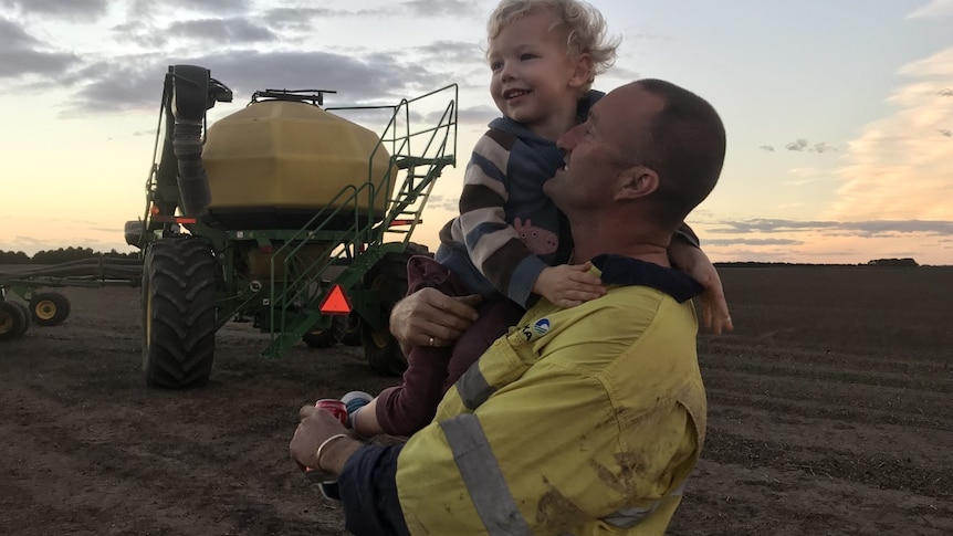 Kirsten's husband on the farm with one of their sons.
