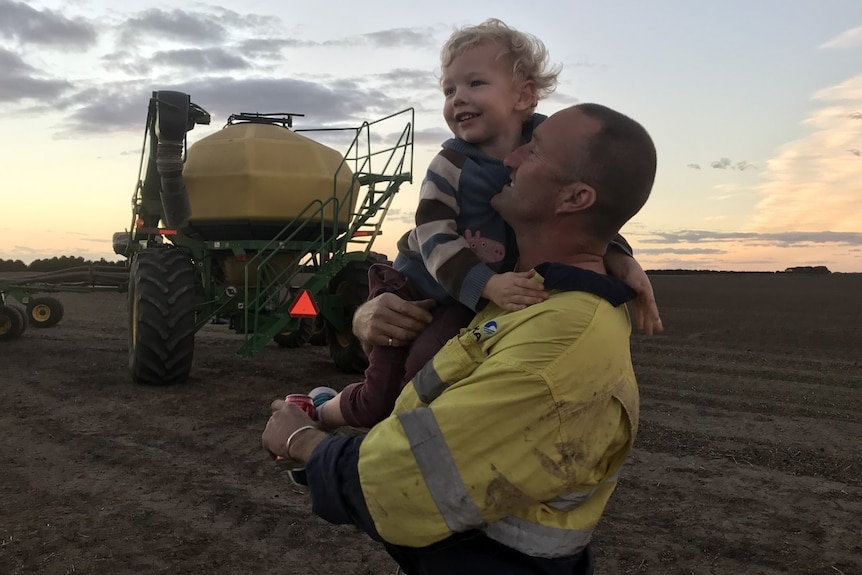 Kirsten's husband on the farm with one of their sons.