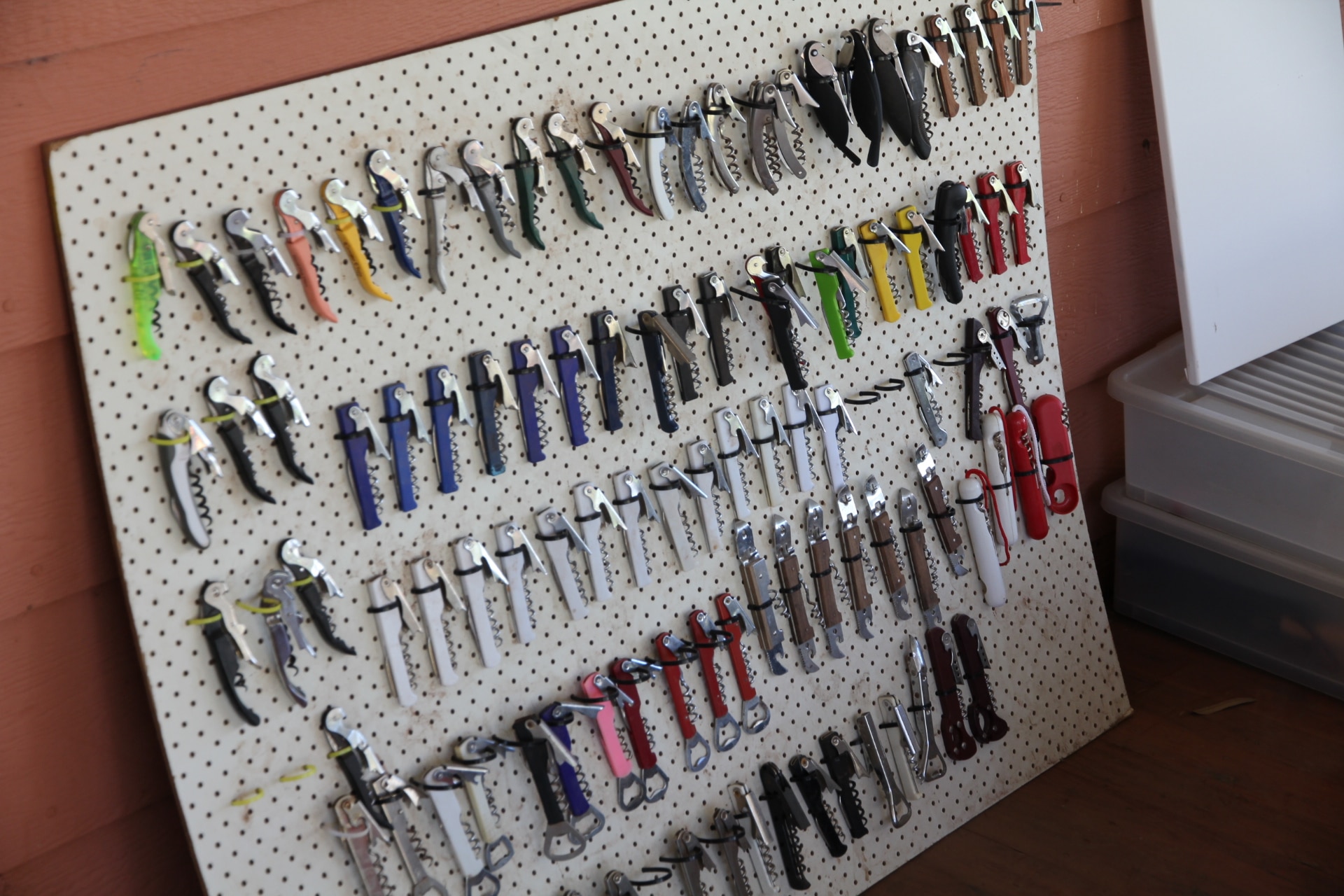 A board with an array of corkscrews in many colours.