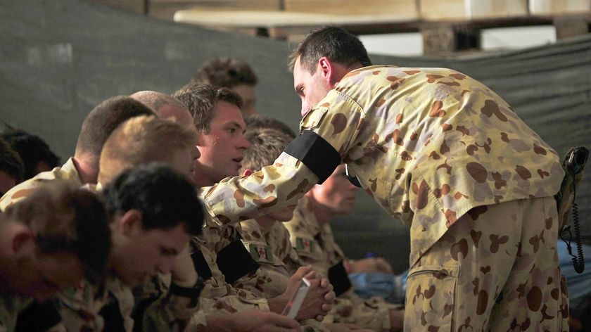 Lieutenant Colonel Mark Jennings consoles members of Charlie Company