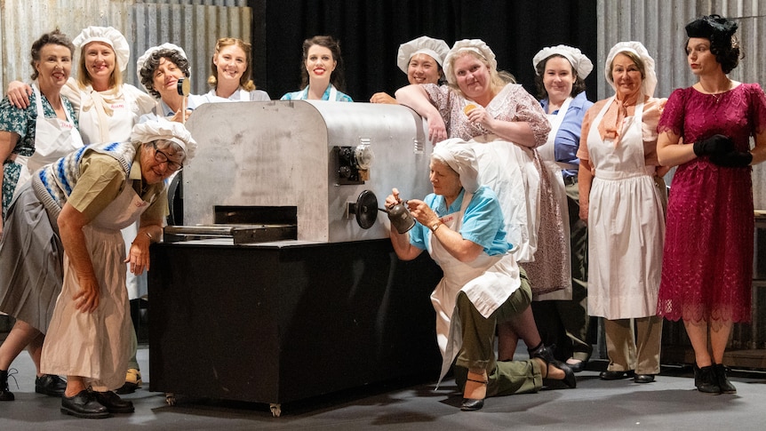 A live stage show staged photograph of female factory workers during WWII.