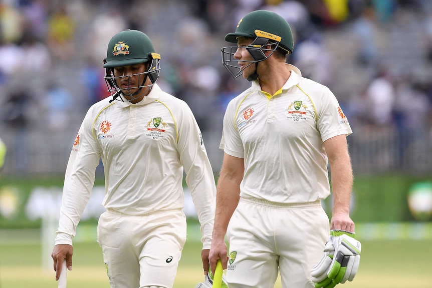 Usman Khawaja and Tim Paine walk off the field