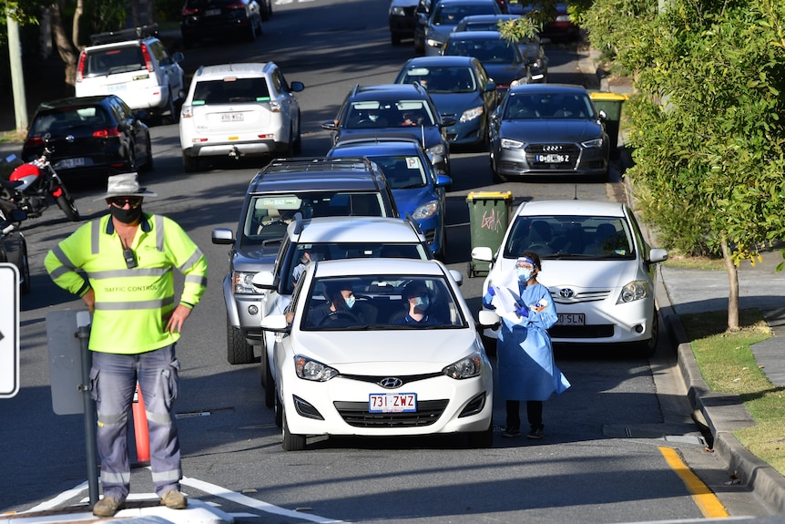 People waiting for COVID-19 testing lined up in their cars at Highgate Hill in Brisbane