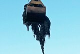 A crane removes wet wipes from a Launceston sewer