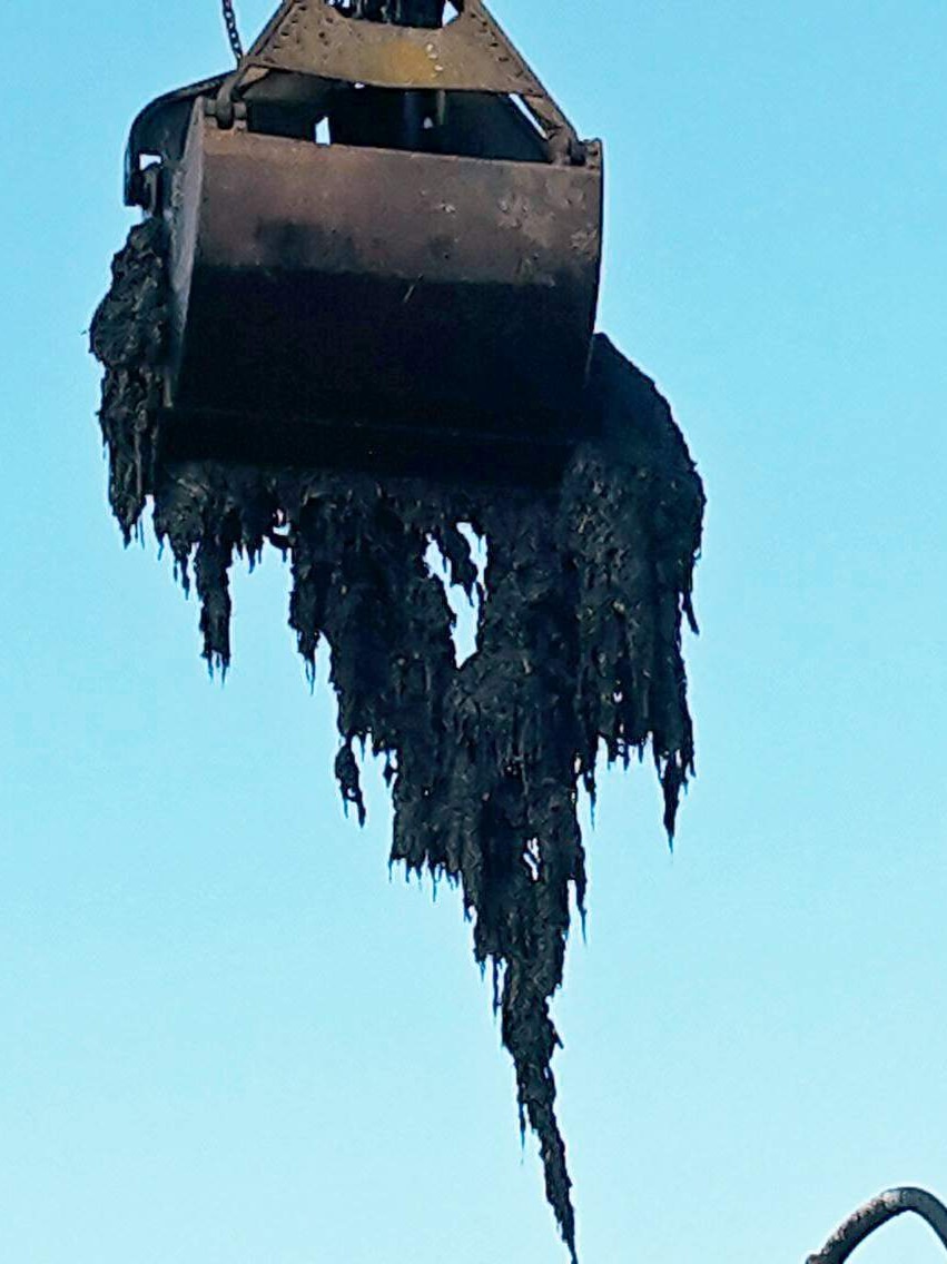 A crane removes wet wipes from a Launceston sewer