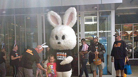 The Easter bunny outside a shop thanking workers