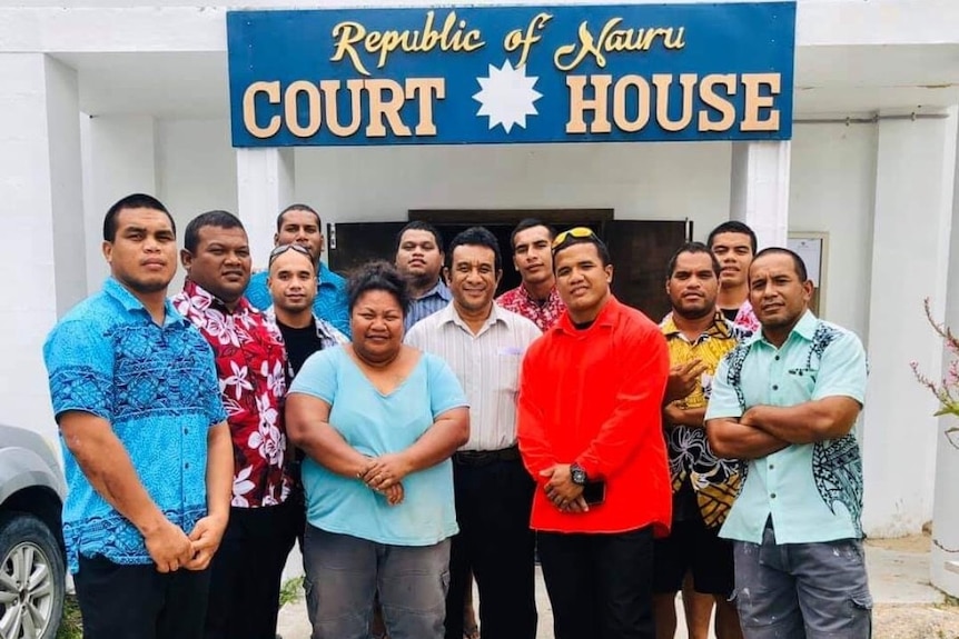 The Nauru 19 post for a photo in front of the court.