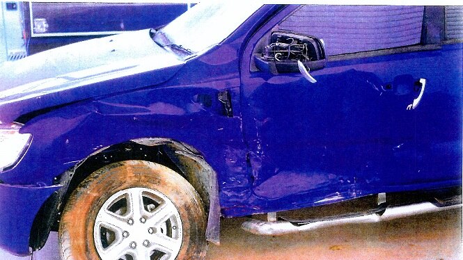 A blue car has dents across its side after a car crash in Darwin.