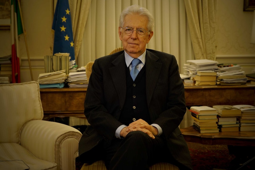 Mario Monti smiles at the camera.