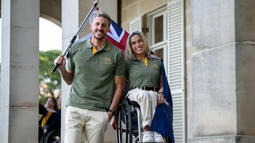 Brenden Hall and Madison de Rozario together with the Australian flag.