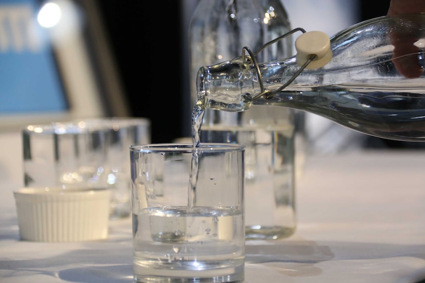 Water being poured into a glass.