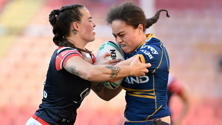 A Parramatta Eels NRLW player is tackled by a Sydney Roosters opponent.
