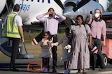 Tamil asylum seeker family arrive in Biloela, Nades kissing hands, family waving to supporters