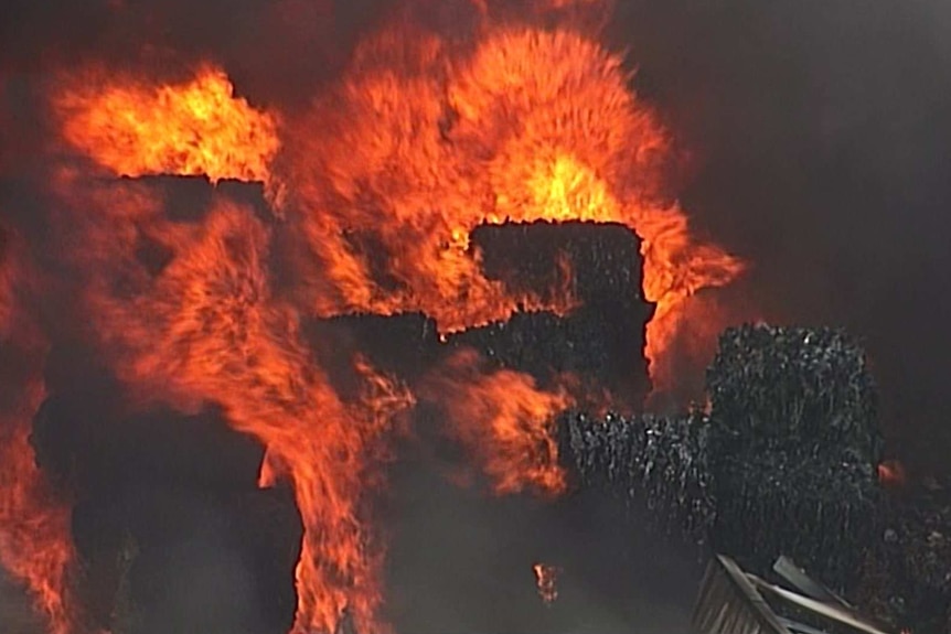 Stacks of material on fire in a warehouse