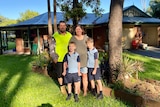 The Presley family, Steve and Rebecca with their sons Zac and Blake, stands outside their house.