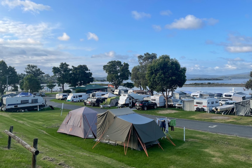 Rows of Caravans line the foreshore of a lake