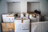 Boxes piled high in a room. 