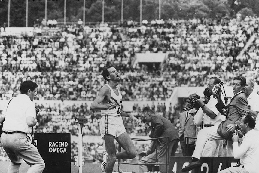 A black and white photo of runner Herb Elliot crossing the finish line.