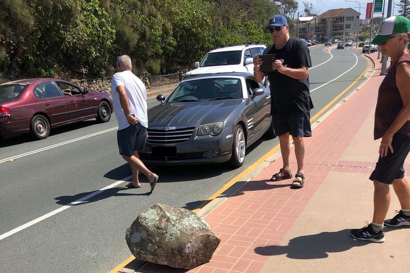 Shocked residents photograph fallen boulder that narrowly missed car at Kirra