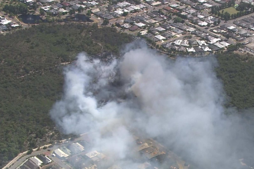 Smoke emanating from bushland near homes