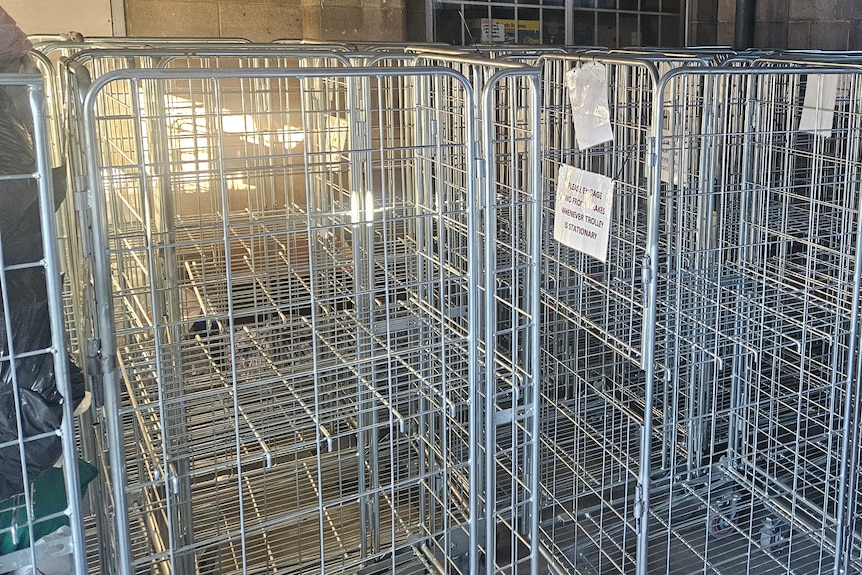 Empty silver storage crates inside a warehouse