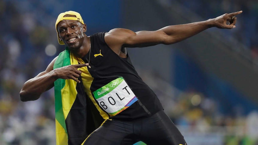 Usain Bolt pulls his famous lightning bolt pose after winning 100m gold in Rio
